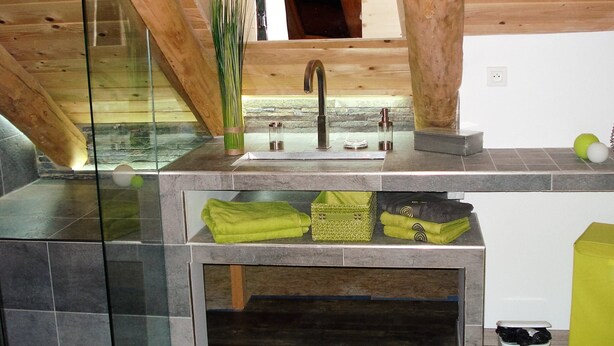 A modern kitchen with a wooden ceiling, a glass backsplash, and a stainless steel sink. - La Grange de l'Ardeyrol (Saint-Clément)