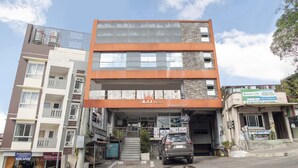 A multi-story building with a prominent 'AJJ Blog' sign on the ground floor. - OYO 549 Sajj Bldg (Baguio)