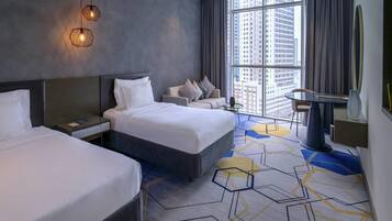 A modern hotel room with two beds, a large window with a city view, a desk, and a chair.