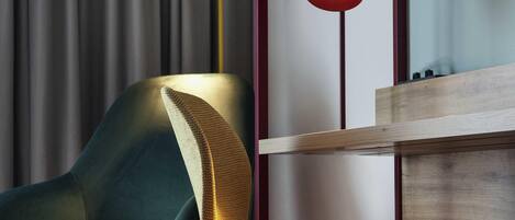 A modern chair with a textured armrest and a cushion, positioned near a wooden panel and a curtain.