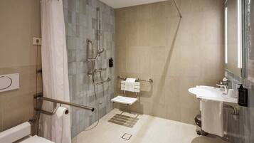 Une salle de bain moderne équipée d’une douche, de toilettes et d’un lavabo.