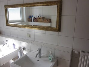 A bathroom with a large mirror, two sinks, and a radiator. - Dream house in Heidelberg city center (Heidelberg)