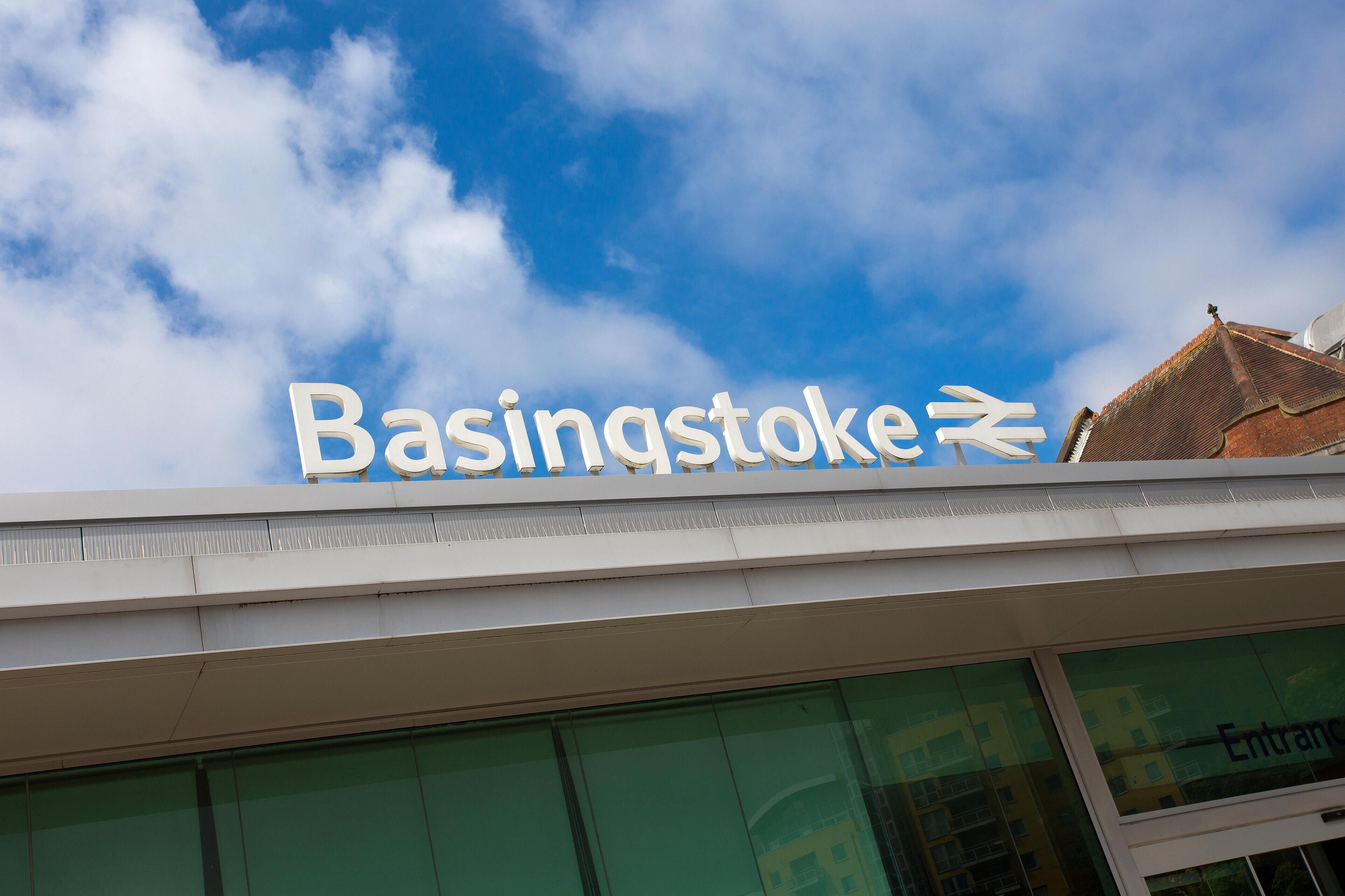 A building with a sign reading "Basingstoke" and an arrow pointing to the right.