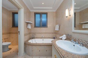 A bathroom with a bathtub, a sink, and a toilet.
