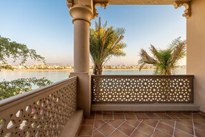 A balcony with a view of a body of water and buildings in the distance. - Exclusive Villa w/ Private Pool, Garden & Beach (Dubai)