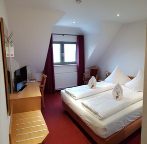 Hypo-allergenic bedding, desk, laptop workspace, blackout curtains