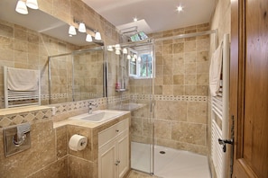 Bathtub, hair dryer, towels, toilet paper