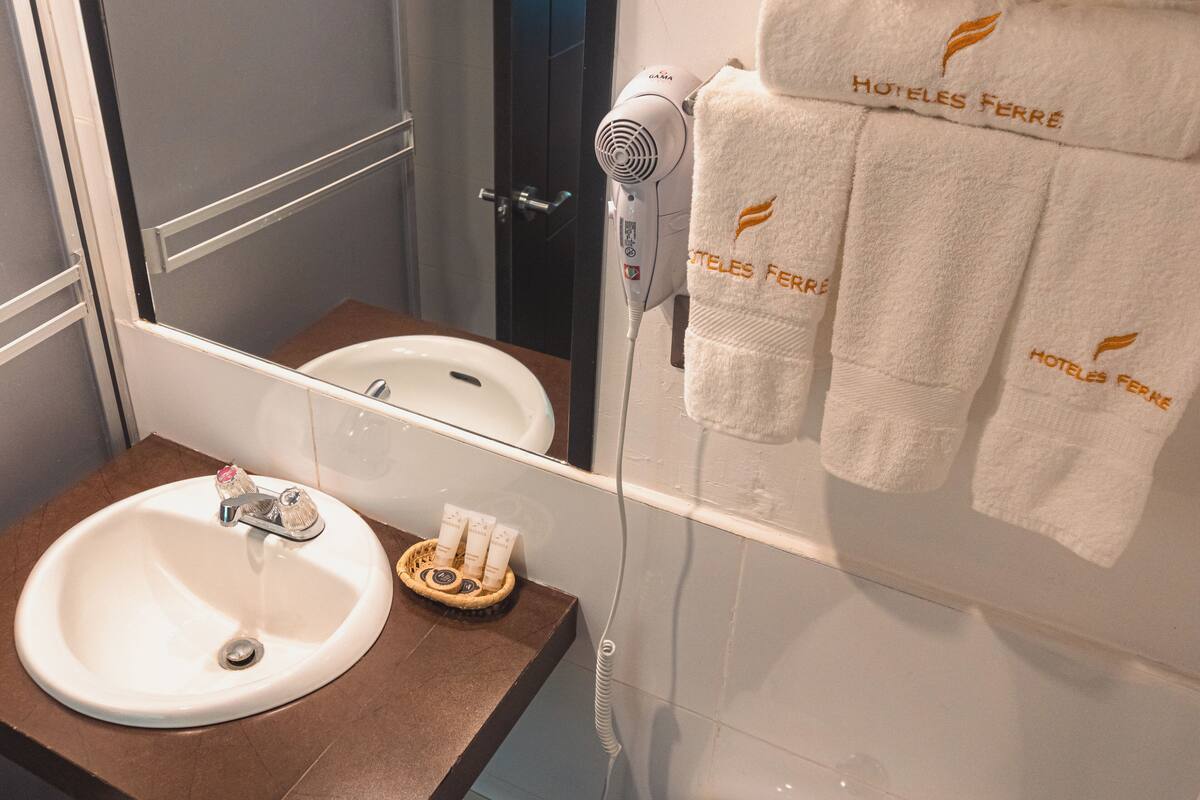 standard twin room | bathroom | shower, hair dryer, towels, soap