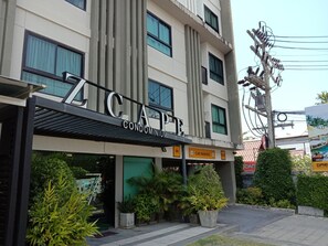 A modern building with a sign reading "ZCAFE CONDOMINIUM".