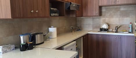 Standard Apartment | Private kitchen | Fridge, microwave, stovetop, high chair