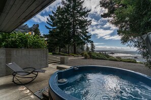 A hot tub with a view of the ocean, a lounge chair, and a concrete structure. - Sanctuary House - Architectural Gem w/ Ocean Views! (Trinidad)