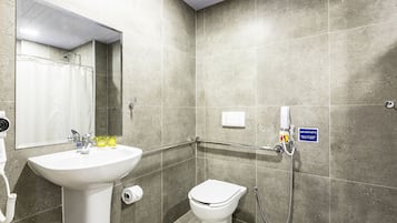 A bathroom with a sink, toilet, and shower.