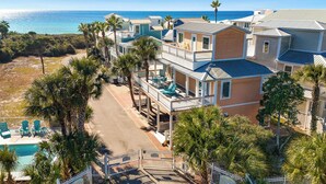 A beachfront property with multiple buildings, a swimming pool, and a gated entrance. - Coral Reef - Private Beach, Bikes, & Beach Chairs (Santa Rosa Beach)