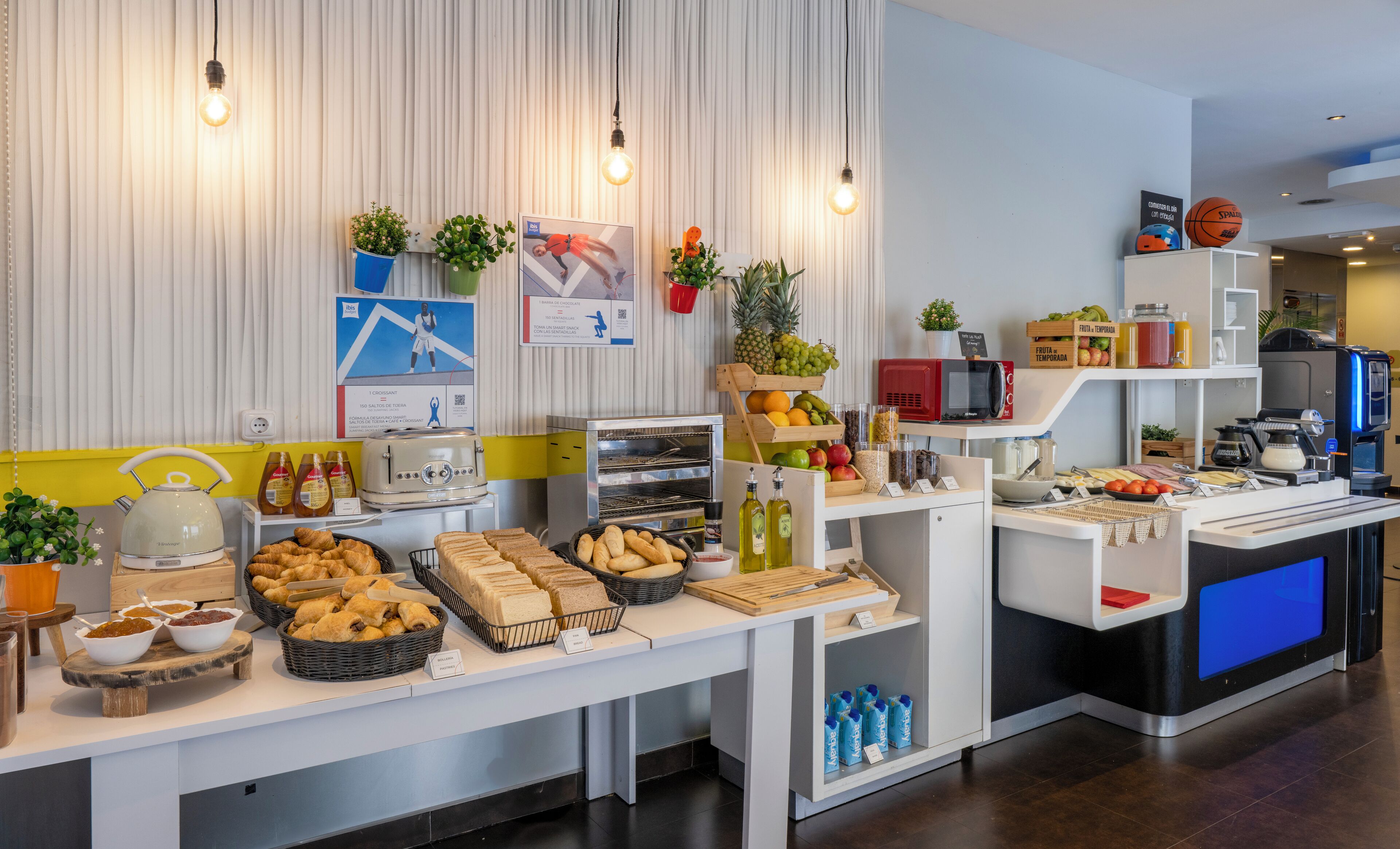 A buffet area with various food items, a toaster, and a microwave.
