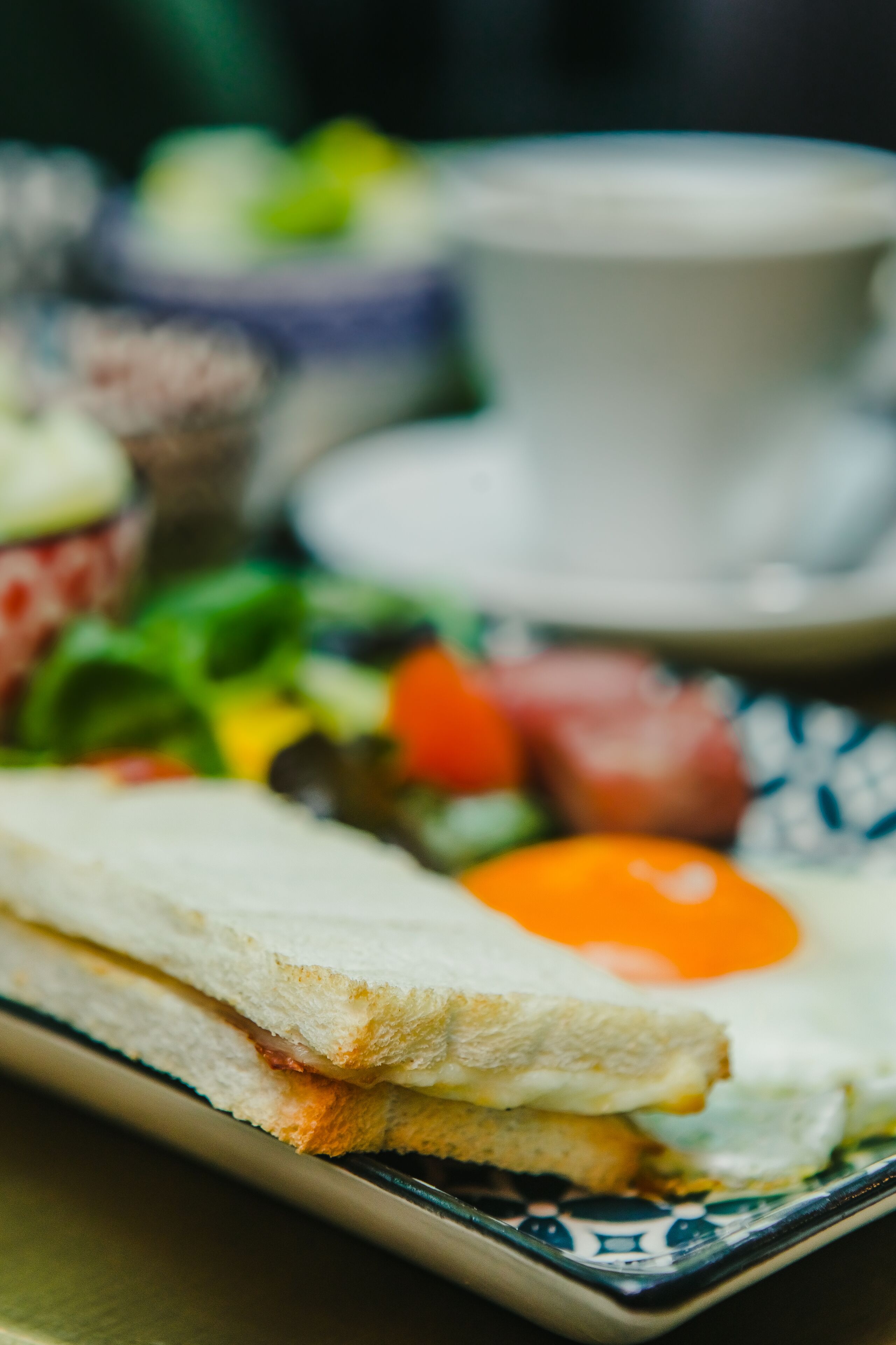 A plate with a sandwich and a fried egg.