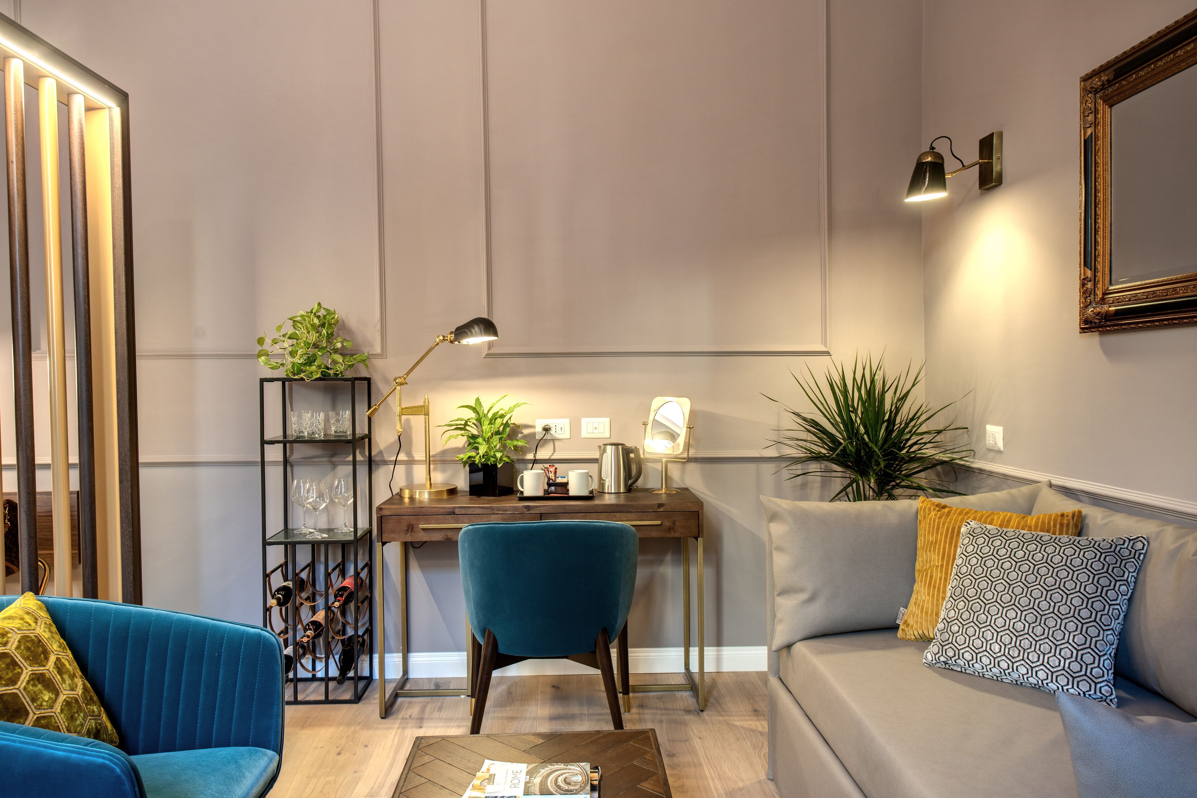 A modern living room with a sofa, a coffee table, a desk, and a bookshelf.