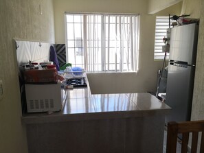 Fridge, microwave, cookware/dishes/utensils, dining tables
