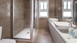 A modern bathroom with a glass-enclosed shower, two sinks, and a large mirror. - Resitour - Apollo Beach Villas (Chlorakas)