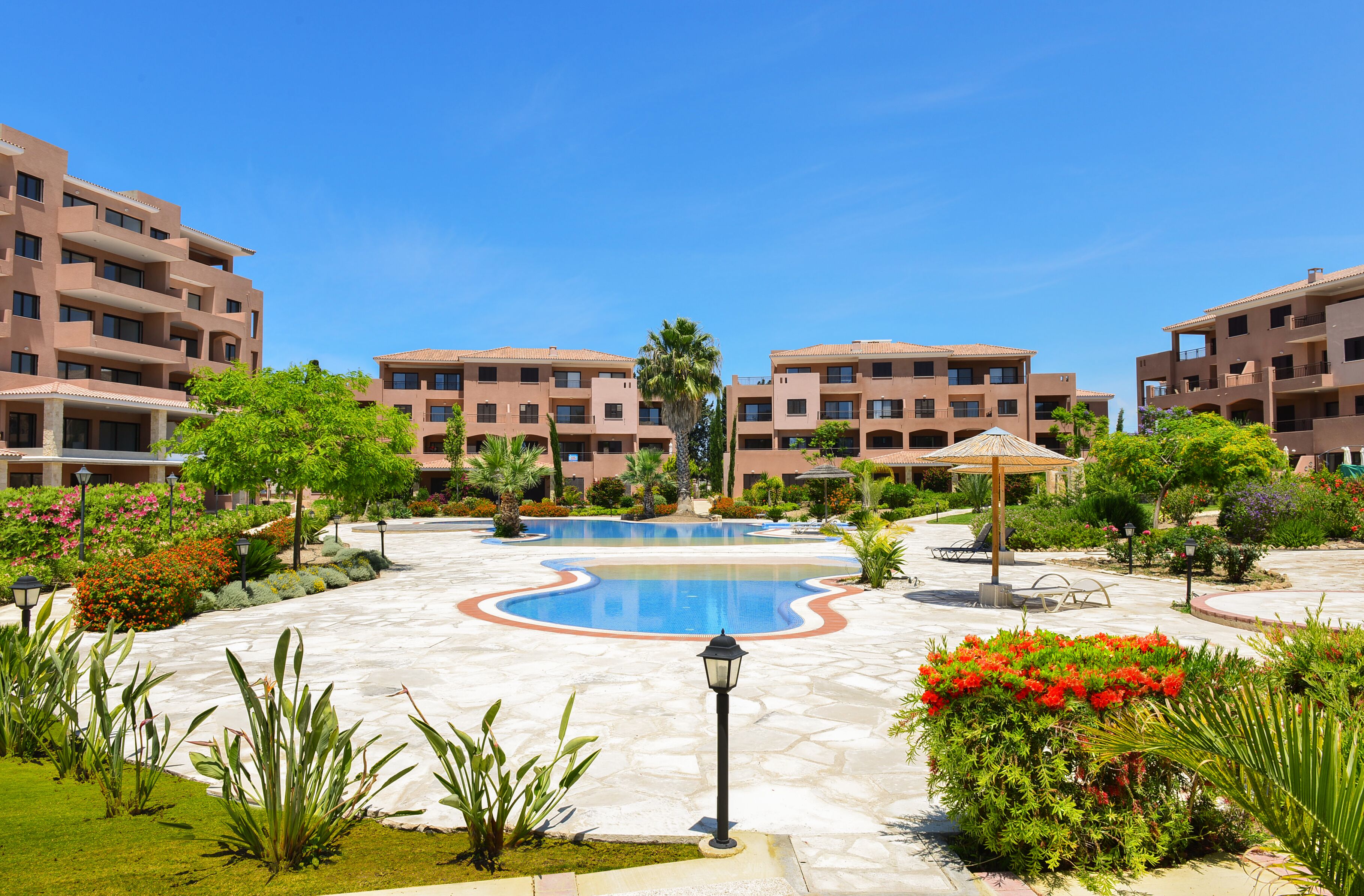 Ein Resort mit zentralem Pool, mehreren Gebäuden und gepflegten Gärten.