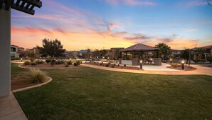 A well-maintained outdoor area with a gazebo, landscaped gardens, and a clear view of surrounding buildings. - Premier Poolside Location | Private Hot Tub + Fire Pit | Ping Pong | Arcadia #13 (Santa Clara)