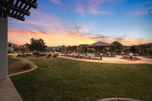 A well-maintained outdoor area with a gazebo, landscaped gardens, and a clear view of surrounding buildings.