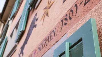 A building facade with a bull and star emblem, and the text "Sternen 1801-2011".