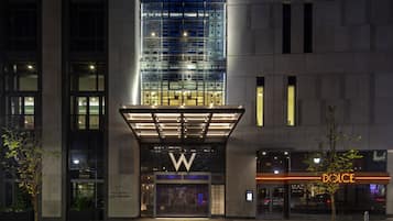 A modern building with a prominent 'W' logo, a glass facade, and a 'Dolce' sign.