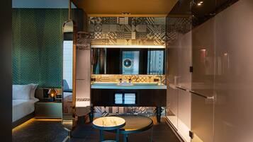A modern bathroom with a large mirror, patterned tiles, and a vanity with a sink.