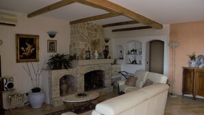 A living room with a stone fireplace, a sofa, and a coffee table.