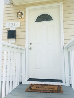 Welcome to your home away from home, where a warm entrance awaits with a convenient mail slot and a cozy doormat.