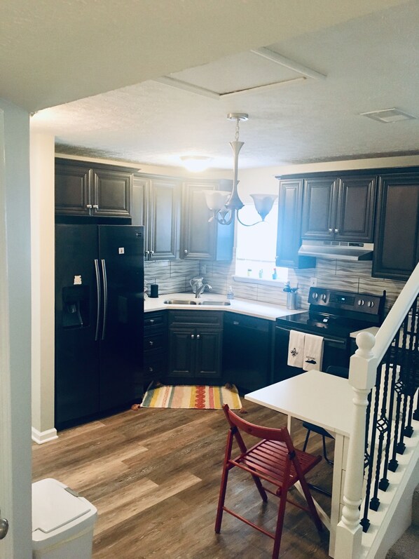 Enjoy a meal in the kitchen, which features an oven and refrigerator.