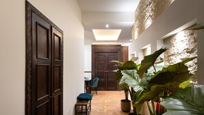 A hallway with a wooden door, a bench, and potted plants. - Exotic Elegance - IR sauna, aircon, 3-bedrooms, 2 bathrooms, Wi-Fi (Krakow, malopolska)
