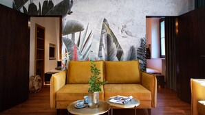 A modern living room with a sofa, coffee table, and a plant. - Exotic Elegance - IR sauna, aircon, 3-bedrooms, 2 bathrooms, Wi-Fi (Krakow, malopolska)