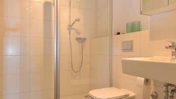 Shower, hair dryer, towels, toilet paper