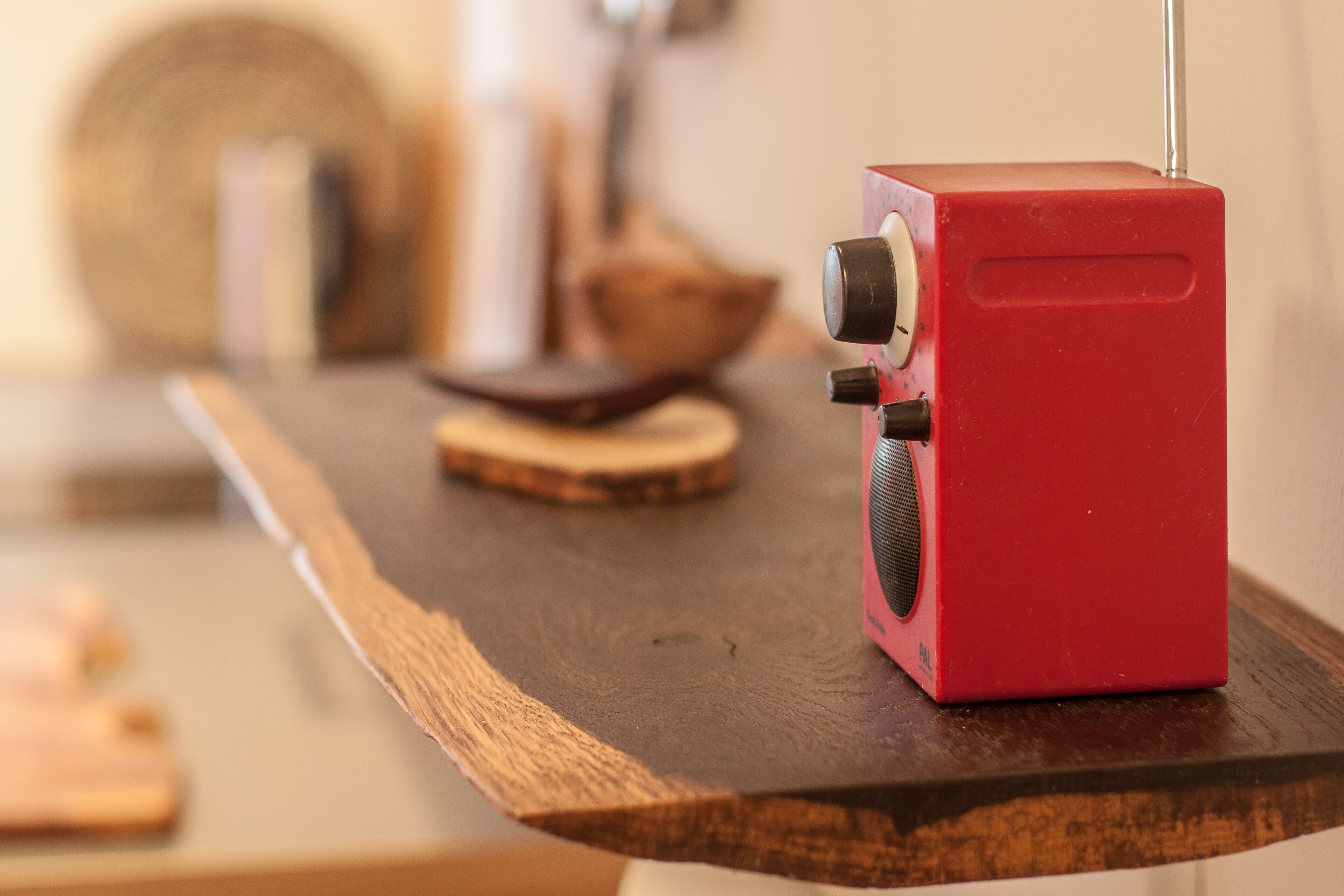 A red object on a wooden surface.