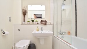 A bathroom with a toilet, sink, and shower. - The Hub - Milton Keynes - Instagram Heaven (Milton Keynes)