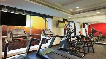 A gym with treadmills, ellipticals, and weight machines.