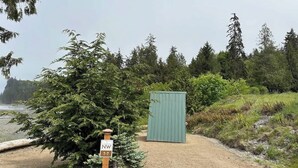 A gravel path leading to a green shed, with a sign indicating NW T-7. - A-Frame (Site 7) Shelter w/ Incredible Ocean View (Port Angeles)