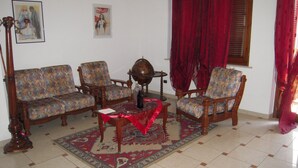 Un salon avec deux canapés, une table basse et un tapis à motifs.