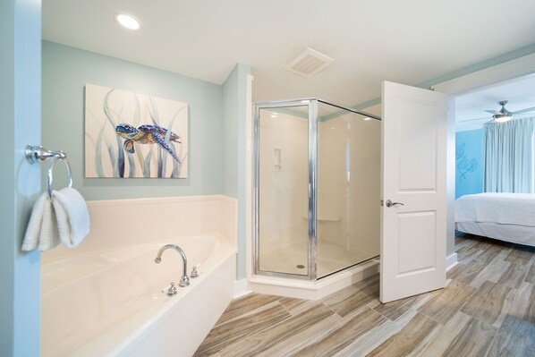 A modern bathroom with a glass-enclosed shower, a large bathtub, and a painting on the wall. - Waterscape A625 ~ Top Floor 2BR ~ Partial Gulf View ~ Beach Service (Fort Walton Beach)