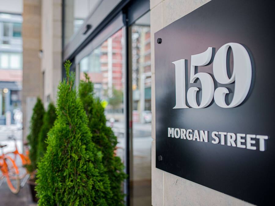 A sign for 159 Morgan Street, indicating the address of a building.