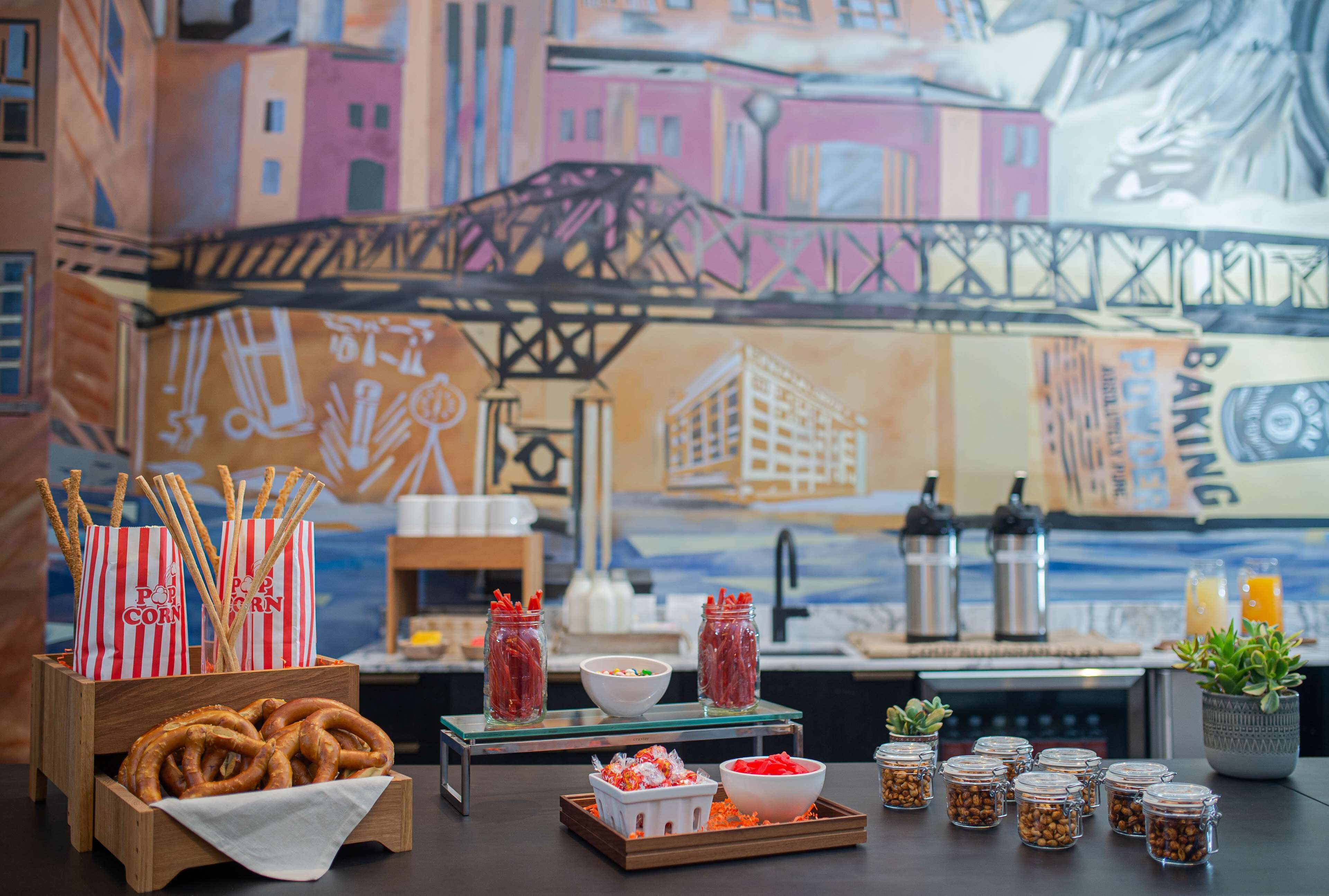 A table with pretzels, popcorn, and jars of spices.