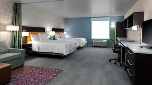A hotel room with two beds, a desk, a chair, a TV, and a window. - Home2 Suites by Hilton Page Lake Powell (Page)