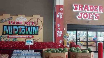 A grocery store interior with watermelons and bottled water on display.