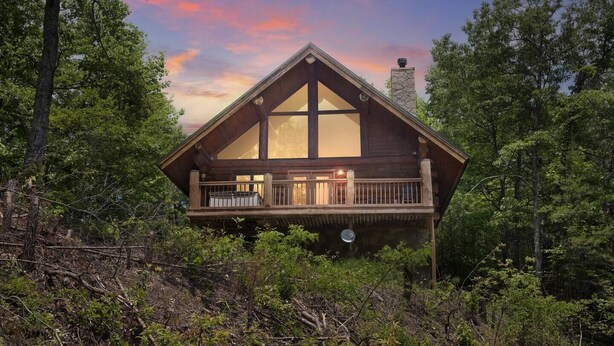 A cabin with a balcony, surrounded by trees. - Star Views - 2BR/New Hot Tub/New Firepit/Grill/Sleeps 8 (Gatlinburg)