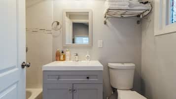 Bathtub, hair dryer, towels, soap