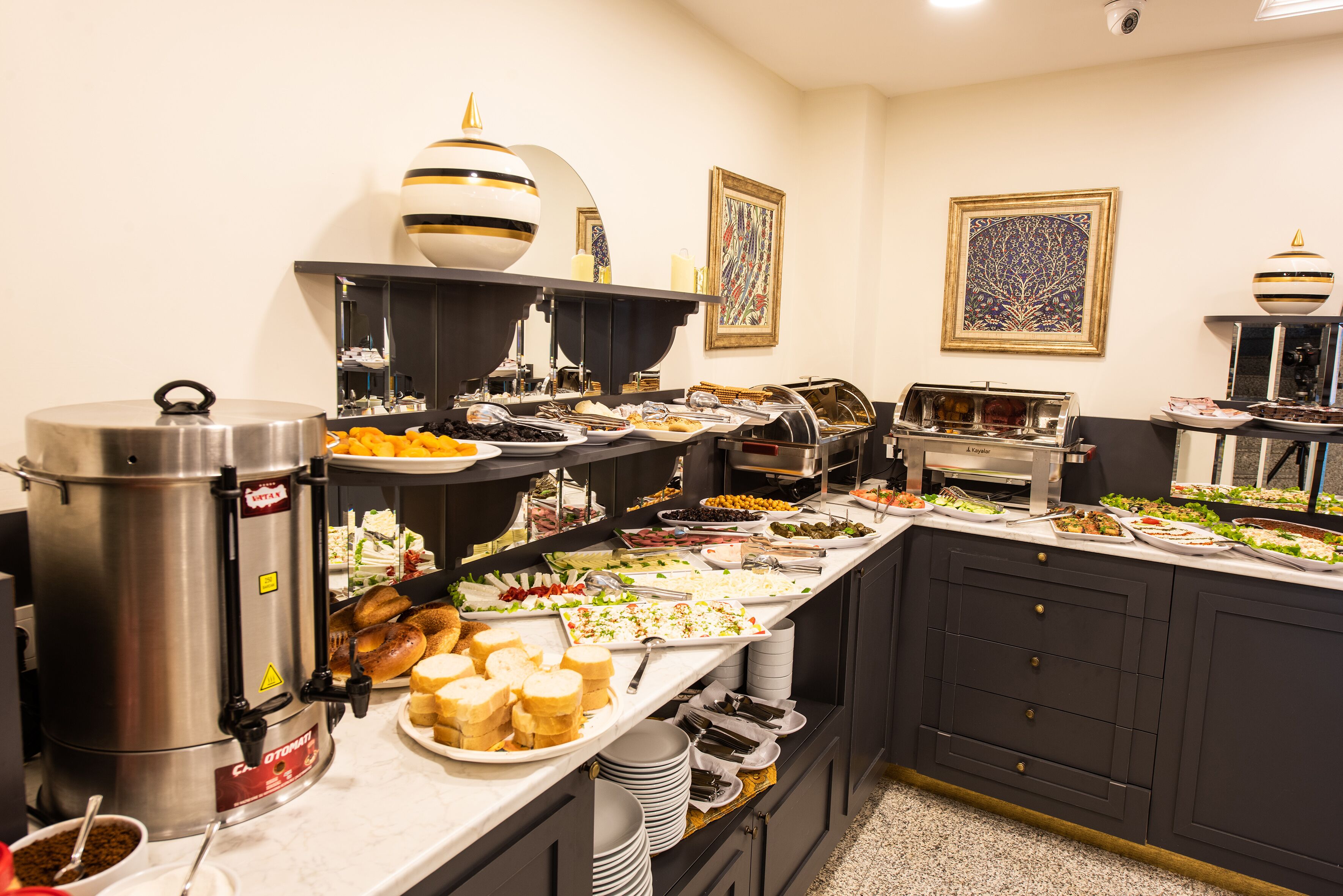 A buffet setup with various food items and a coffee station.