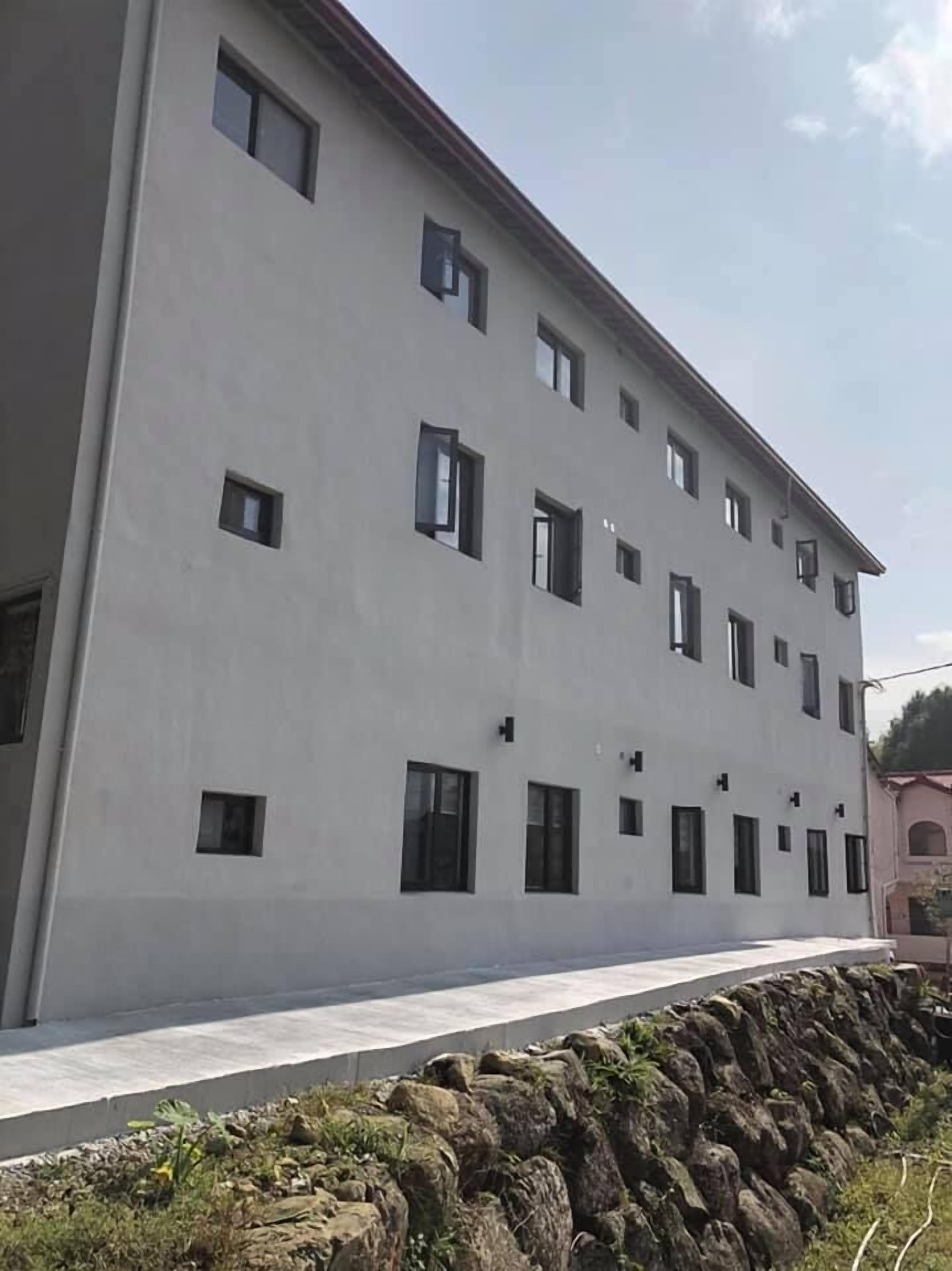 A multi-story building with a flat facade and evenly spaced windows.
