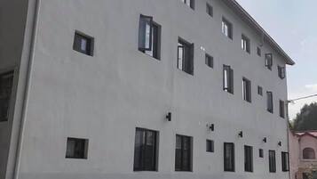 A multi-story building with a flat facade and evenly spaced windows.
