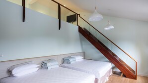 A bedroom with two beds, a wooden staircase, and pendant lights. - Minzu Hotel (Lugu)